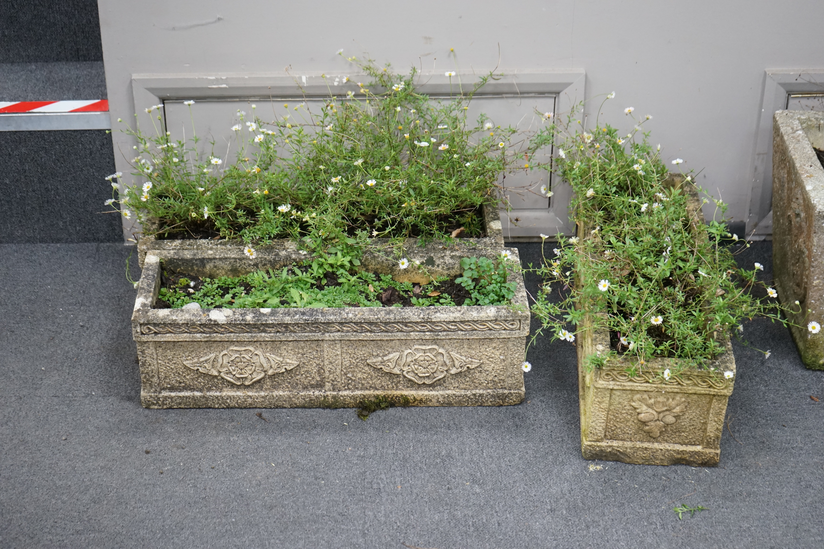 A graduated set of three rectangular reconstituted stone garden planters